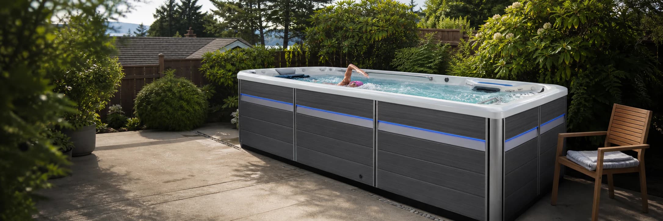 Woman swimming in a realistic Endless Pools E500 swim spa at a North Shore home in British Columbia