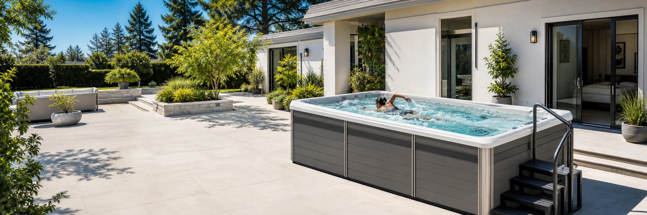 Platinum R220 swim spa with an active swimmer on a sunny patio
