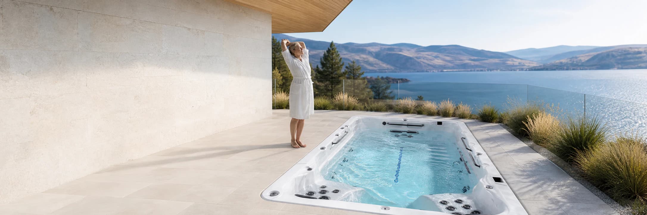 Woman stretching beside a realistic Platinum Spas Eros swim spa overlooking Okanagan Lake