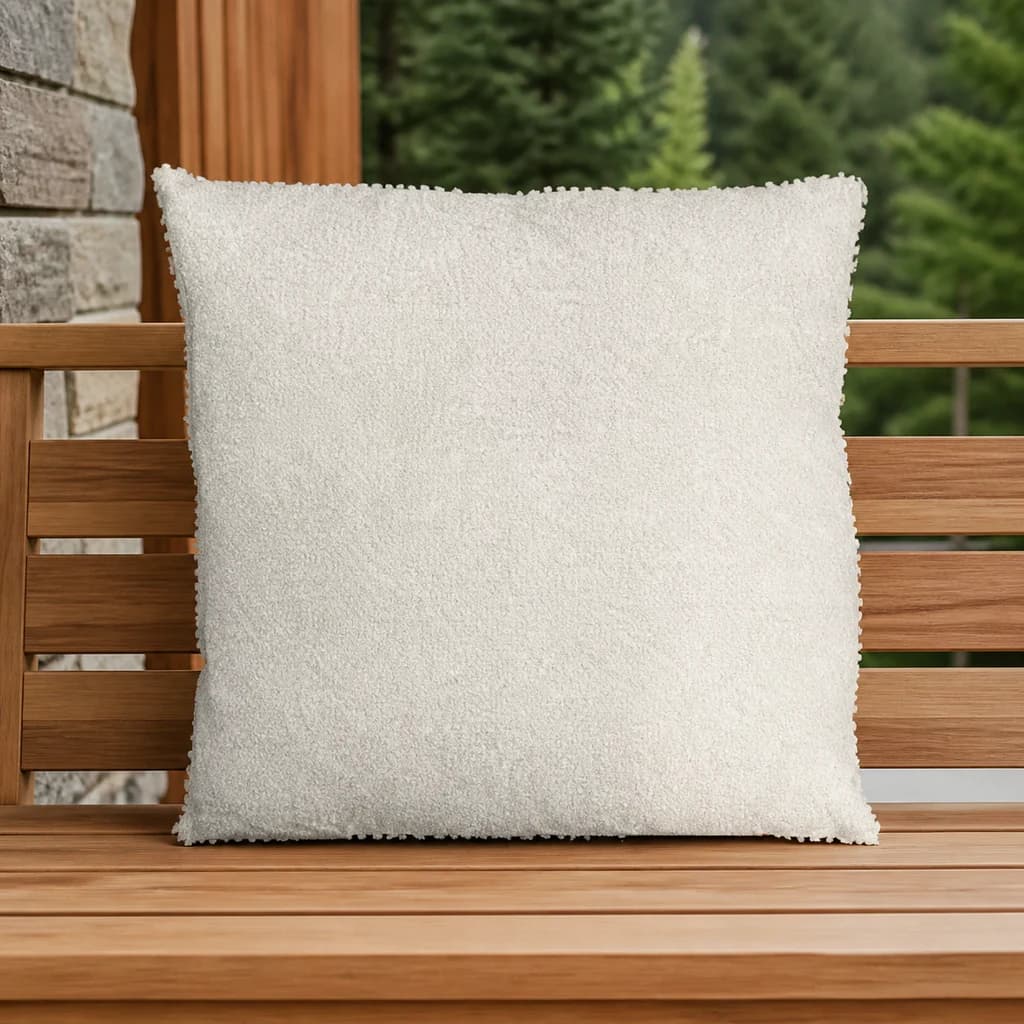 Ratana CU01216 ivory 16-inch square toss pillow on a teak outdoor bench.
