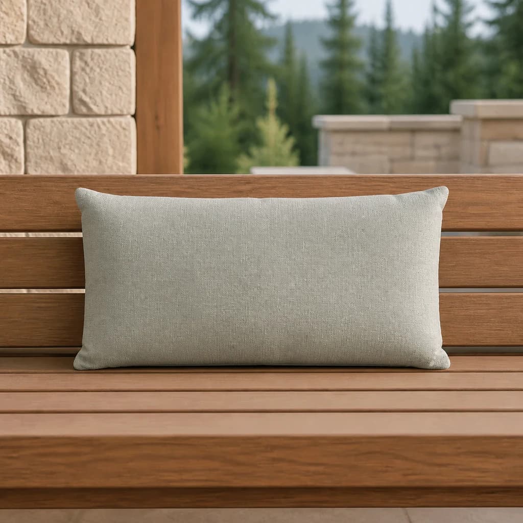 Ratana CU01220 pale gray-sage rectangular toss pillow on a teak outdoor bench.