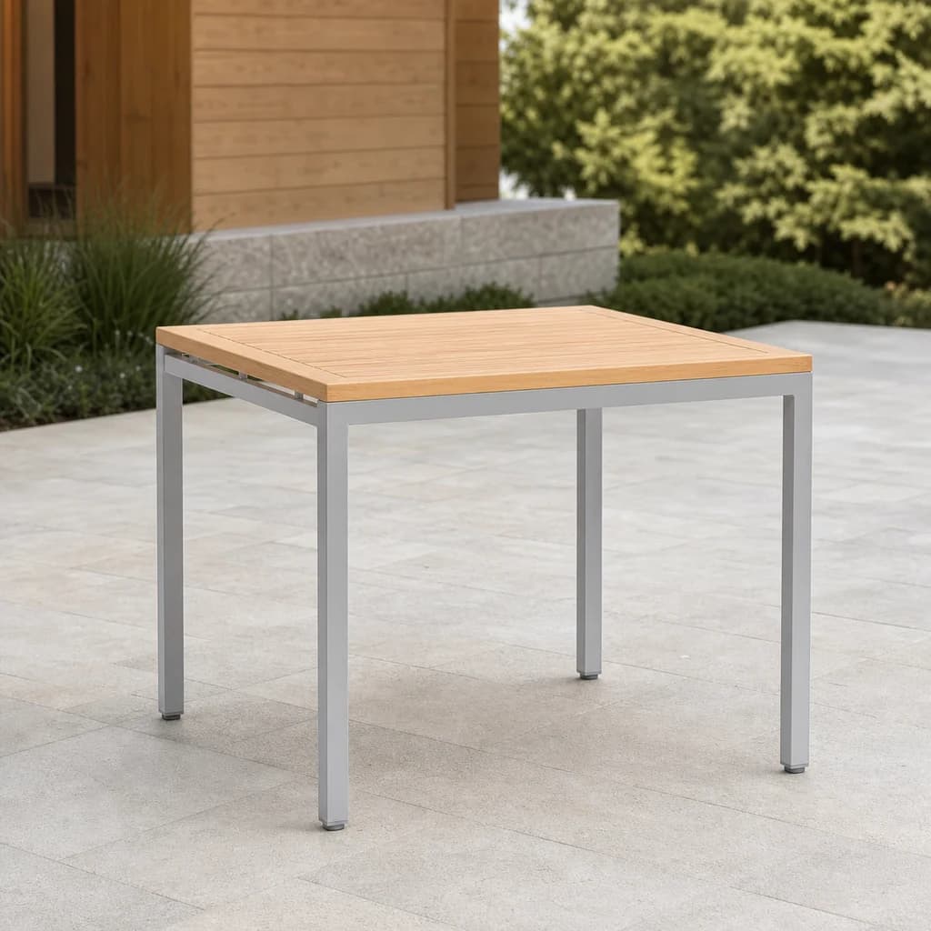 Ratana FN28210A Zuni square dining table with warm slatted Everrawood top and silver aluminum frame on a stone terrace.