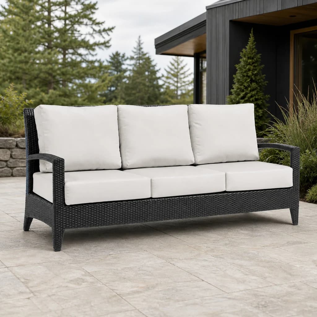 Ratana FN28303 New Miami Lakes Sofa with six ivory cushions and dark woven frame on a premium evergreen patio.