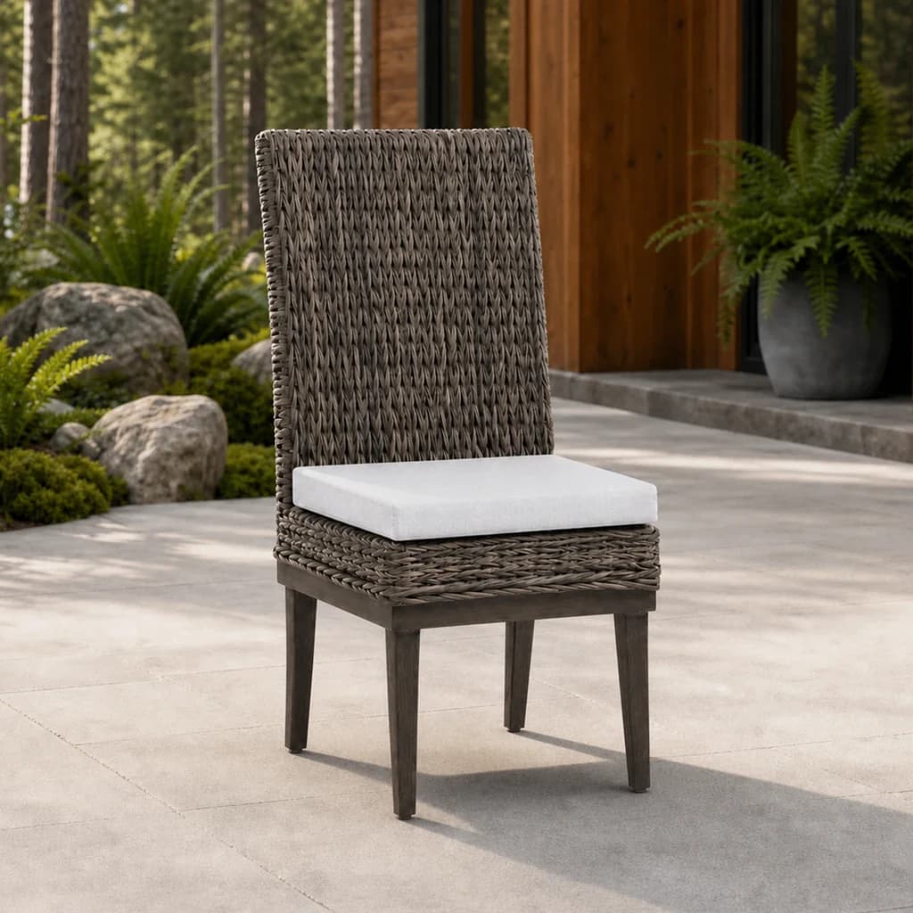 Ratana FN51711 Boston armless Dining Side Chair with light gray cushion and taupe woven back on a stone patio.