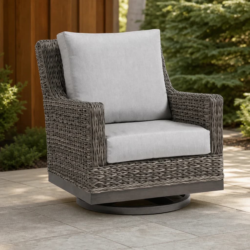 Ratana FN51790 Boston Swivel Gliding Club Chair with light gray cushions and taupe wicker on a garden patio.