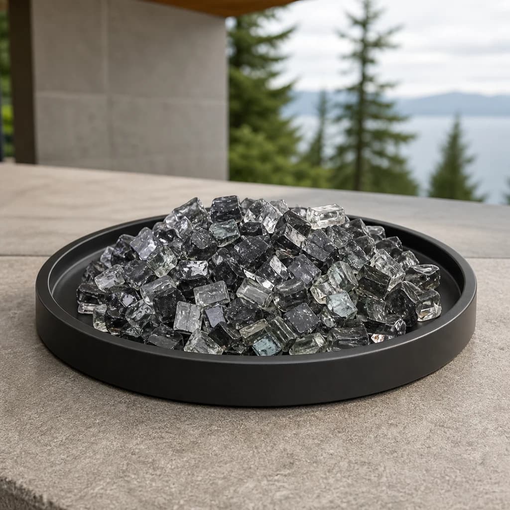 Ratana FN52400BRZ-RGLZ-RGLZ-RGLZ-RGLZ-RGL smoky graphite reflective fire glass displayed in a black outdoor fire-pit tray.