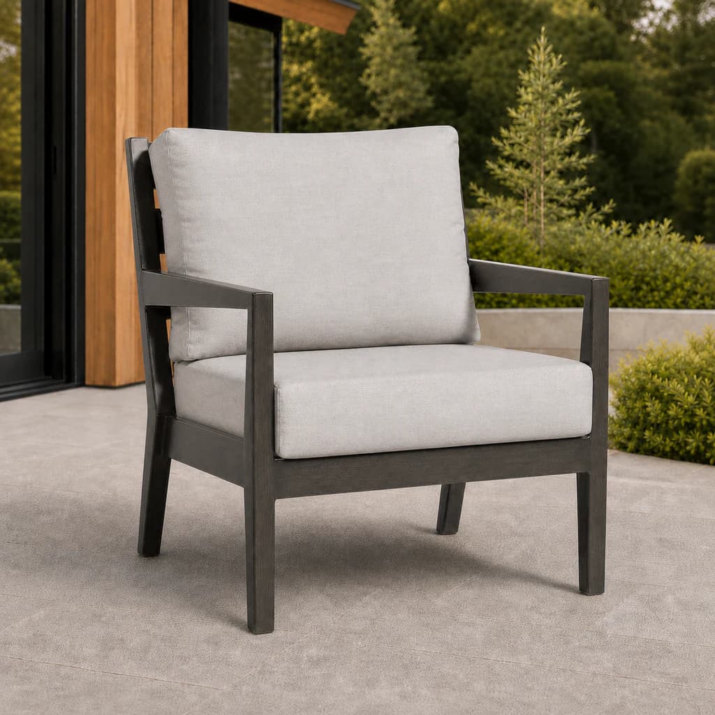 Ratana FN54401 Lucia Club Chair with charcoal aluminum frame and pale gray cushions on a Pacific Northwest patio.