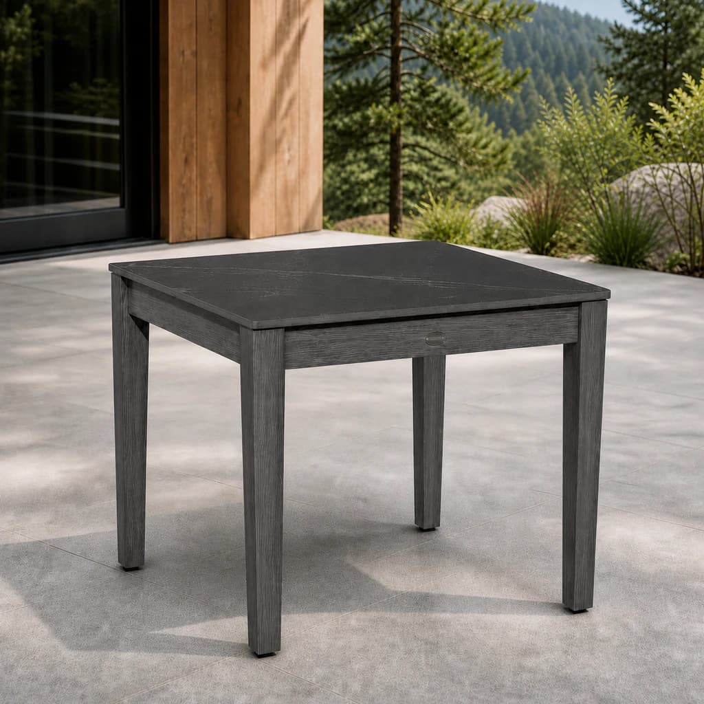 Ratana FN54405 Lucia square end table with black sintered stone top and charcoal aluminum frame on a stone patio.