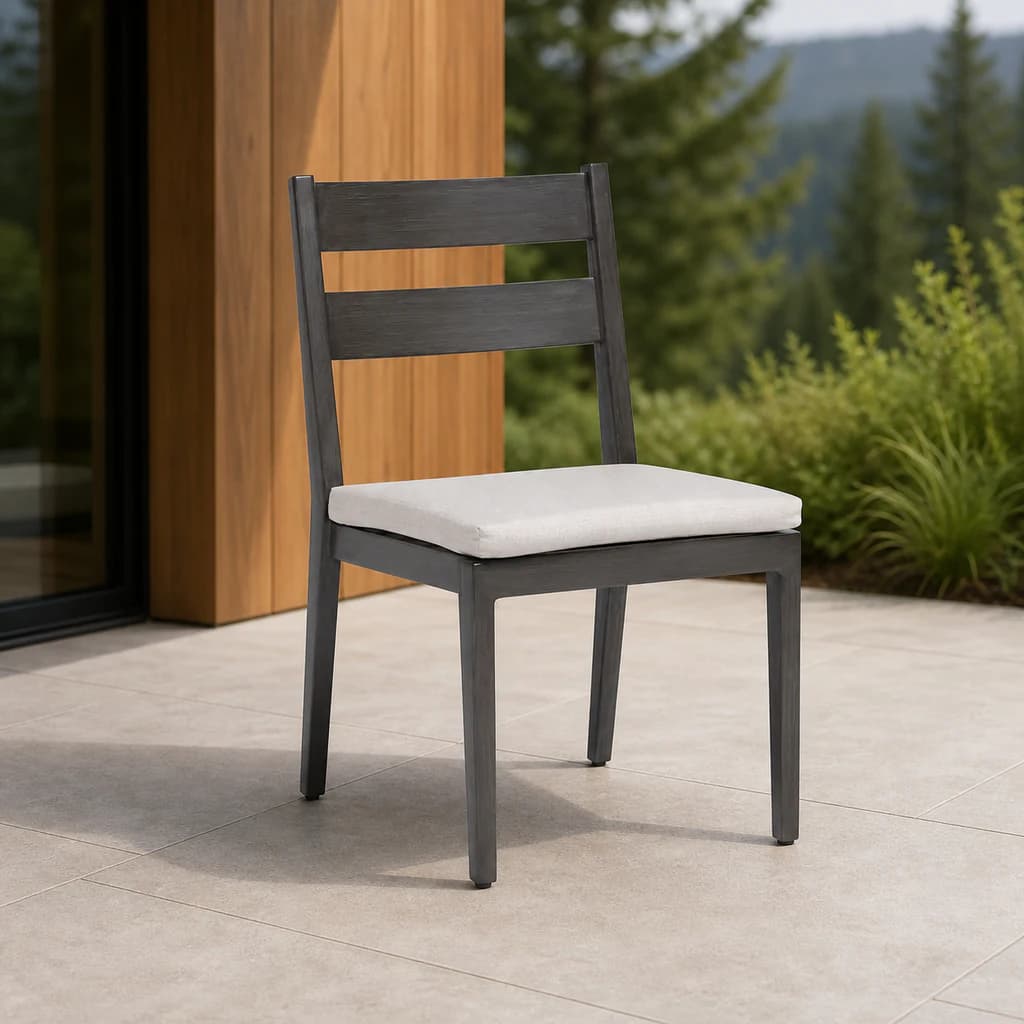 Ratana FN54411 Lucia Dining Side Chair with charcoal aluminum ladder back and pale seat cushion on a mountain patio.