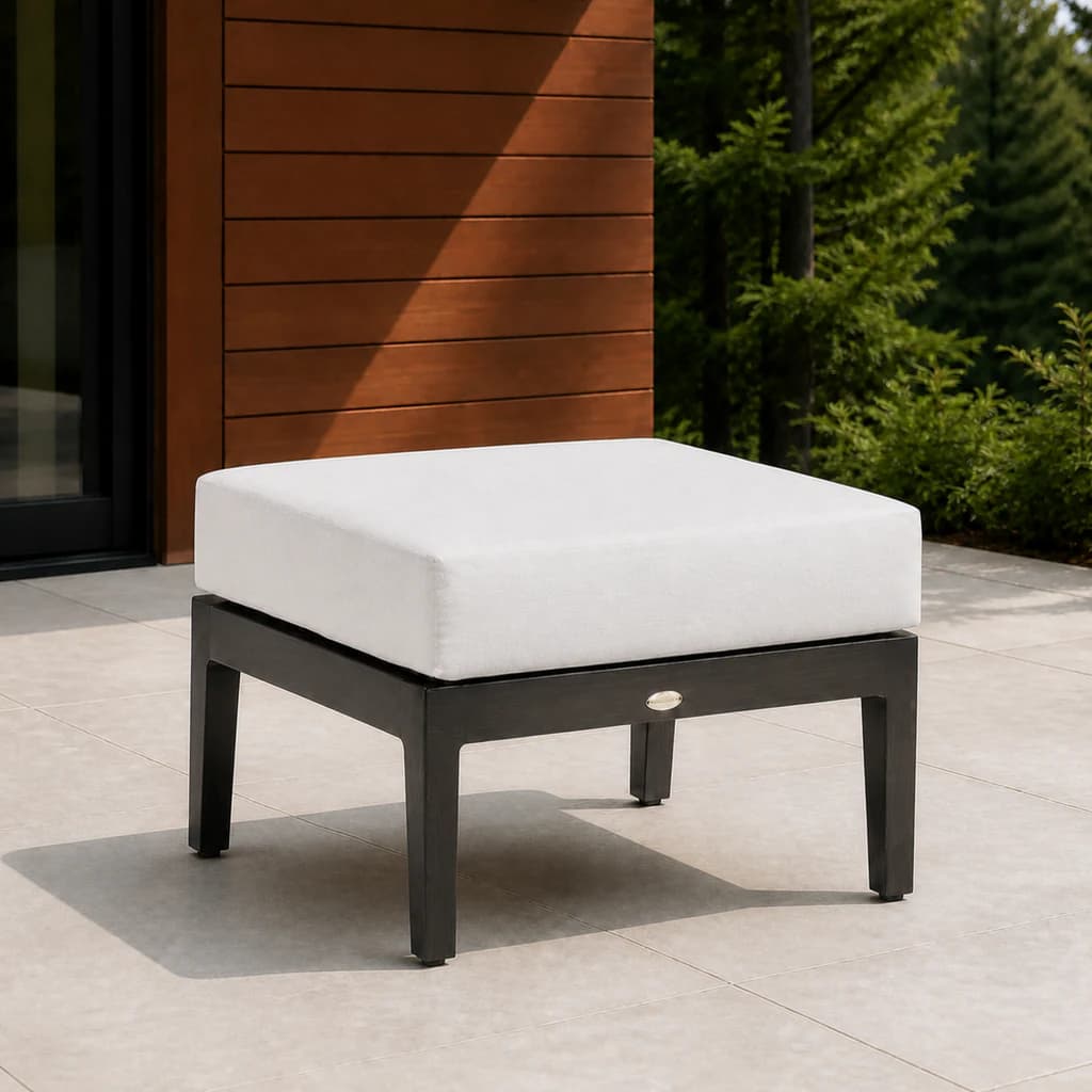 Ratana FN54416 Lucia Ottoman with charcoal aluminum frame and thick pale cushion on a modern cedar patio.