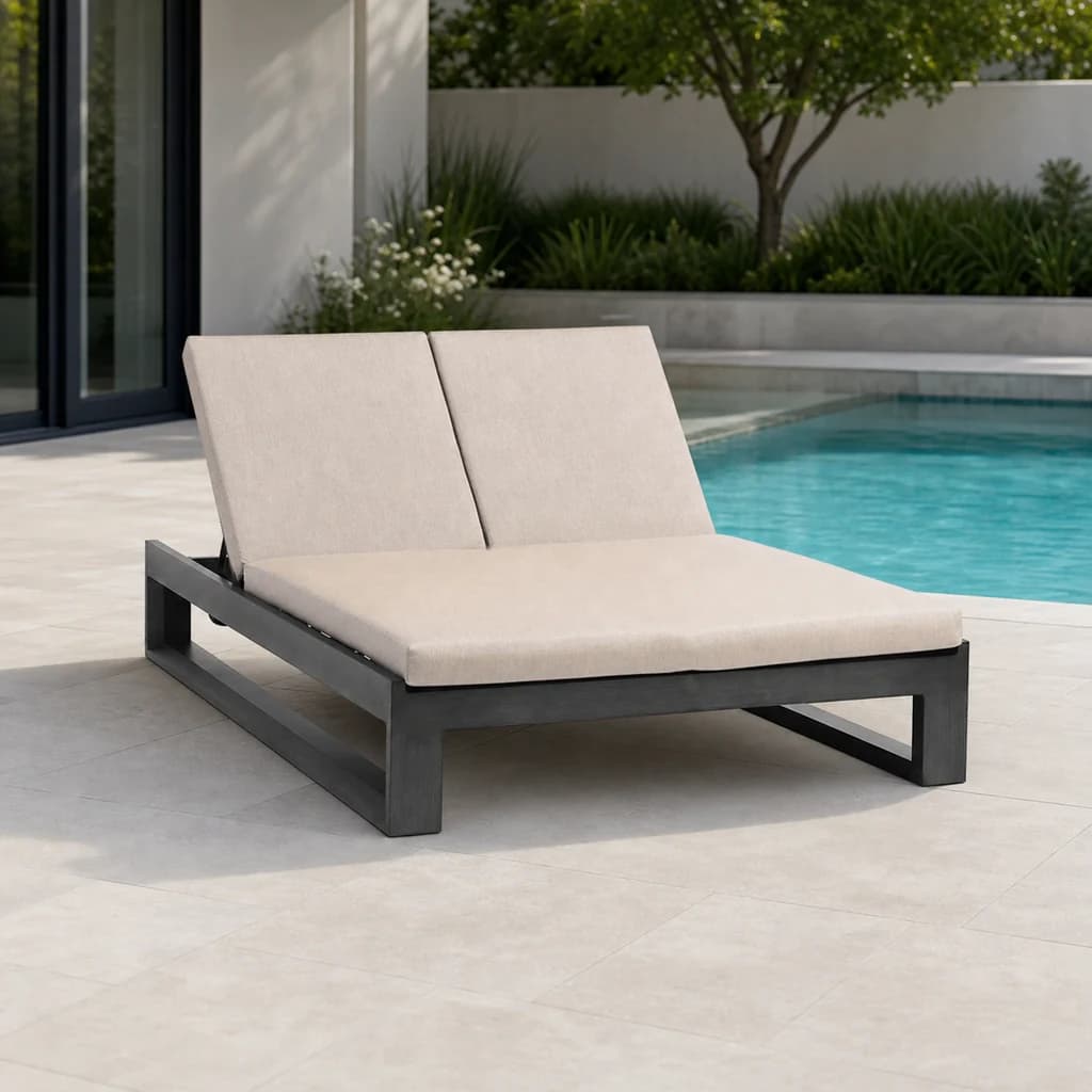 Ratana FN57021 Double Chaise Lounger beside a pool on a landscaped terrace.