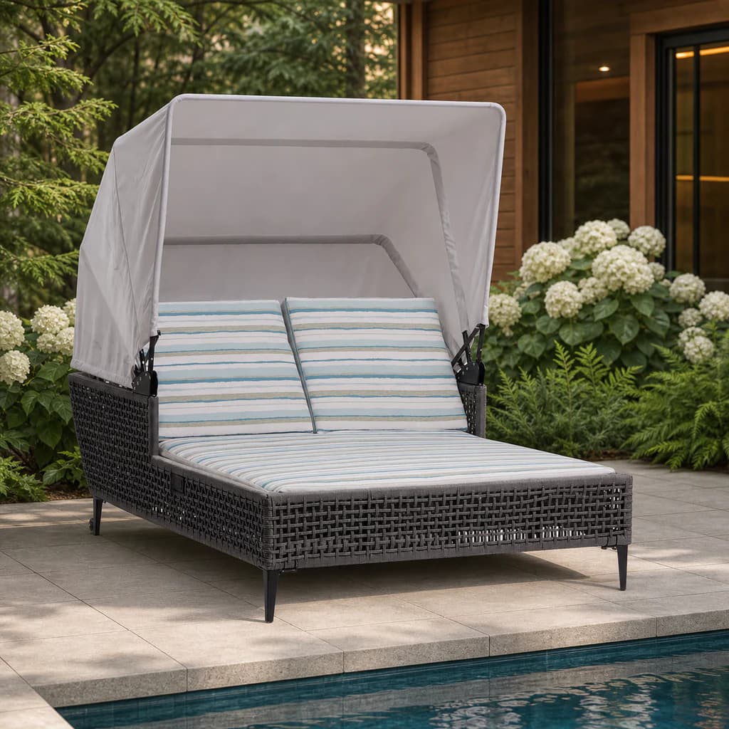 Ratana FN57271 Genval two-person canopy daybed beside a garden pool.