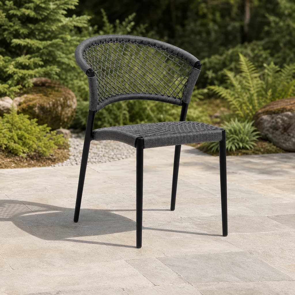 Ratana Ria charcoal open-rope dining side chair on a Pacific Northwest garden terrace.