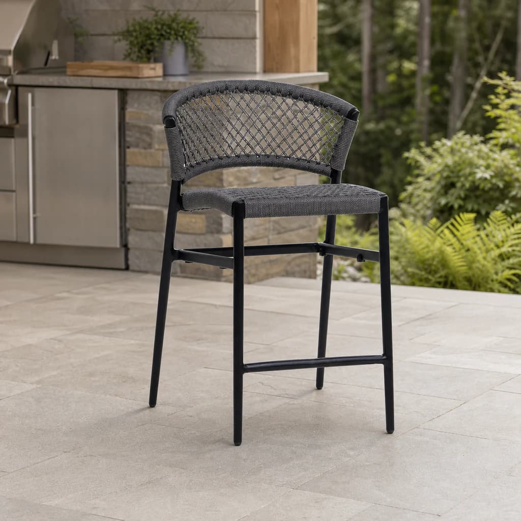 Ratana Ria charcoal open-rope counter chair on a Pacific Northwest outdoor kitchen terrace.