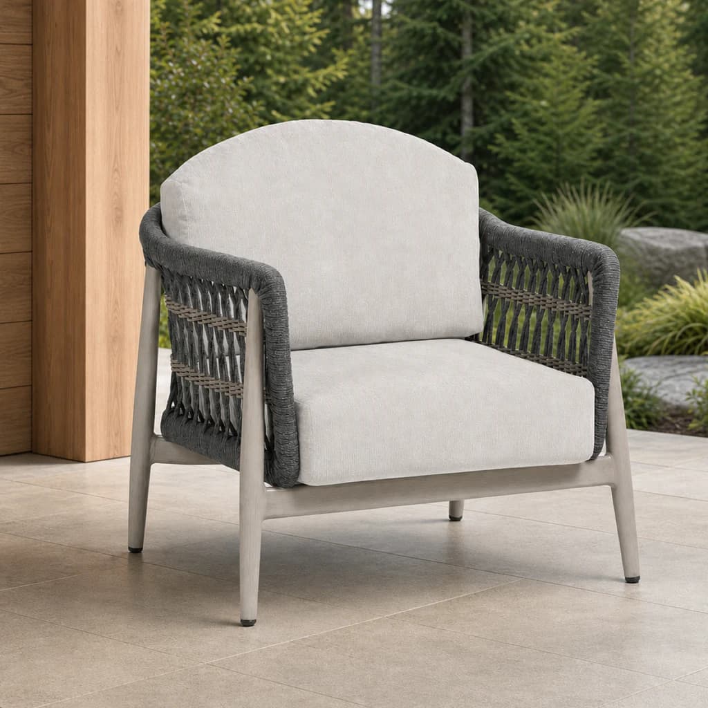 Ratana FN60101 Coconut Grove Club Chair in light cushions on a covered evergreen patio.