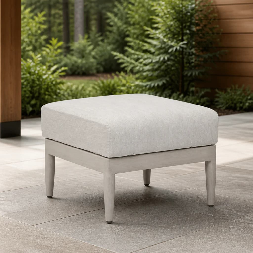 Ratana FN60116 Coconut Grove Ottoman with a light cushion on a cedar and stone patio.