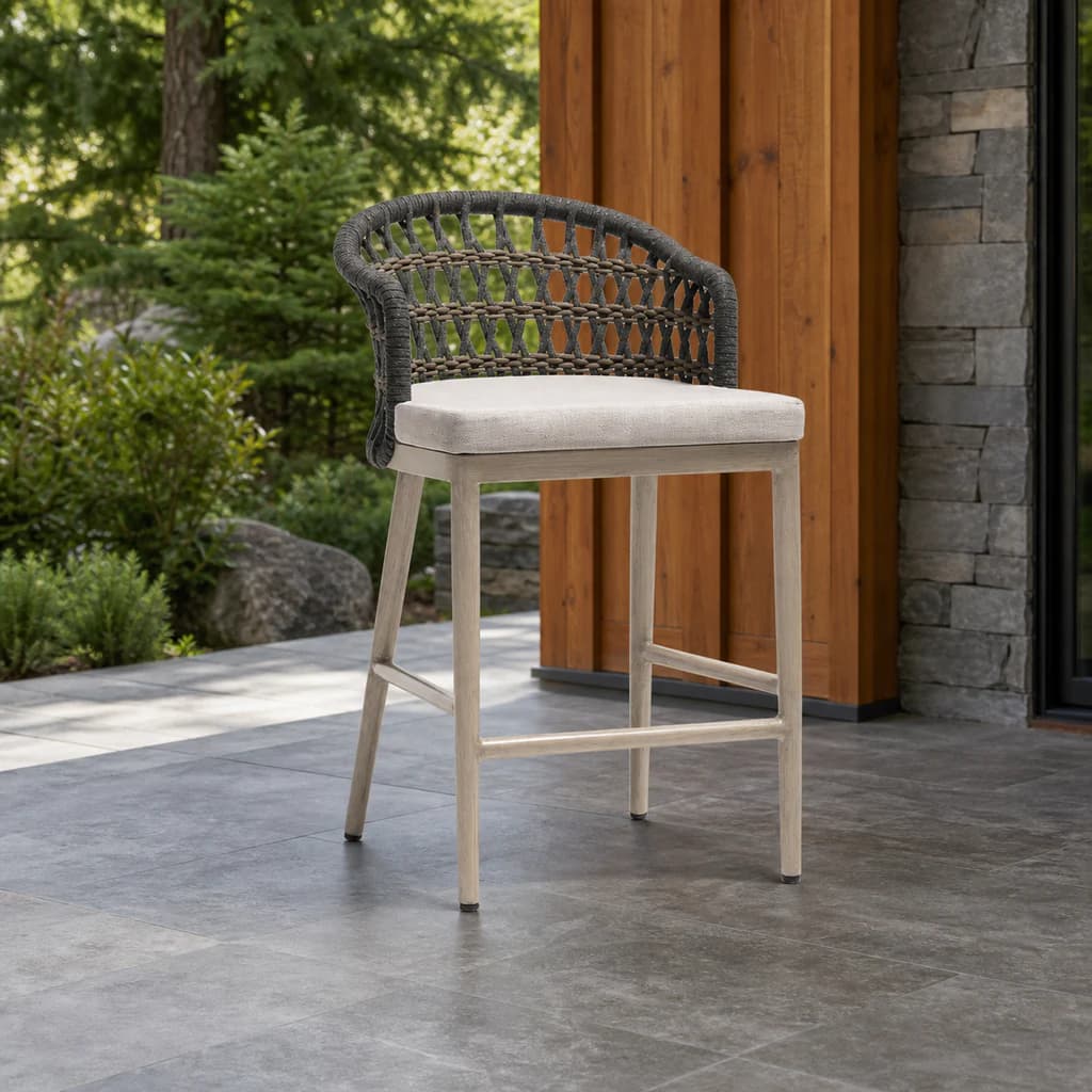 Ratana FN60140 Coconut Grove counter chair with footrest on an evergreen patio.