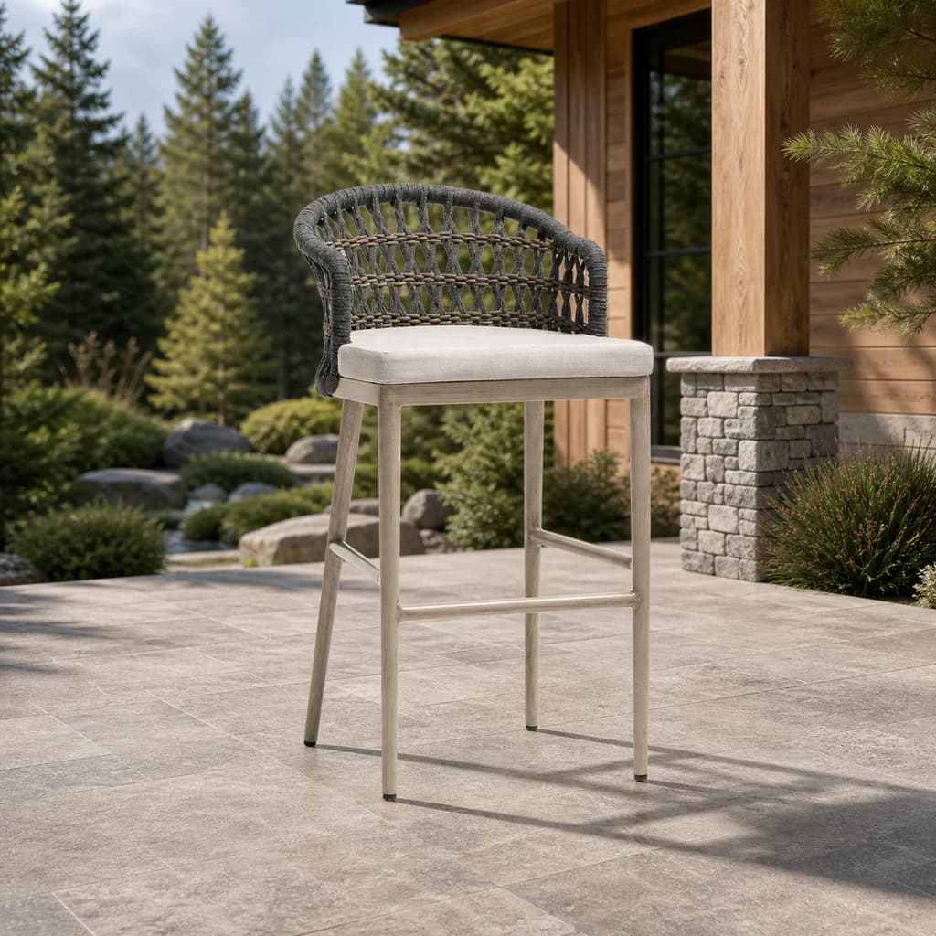 Ratana FN60141 Coconut Grove bar chair with tall frame on a forest patio.