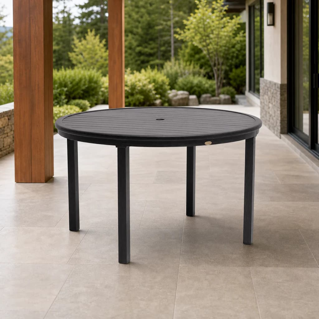 Ratana FN61110 Canbria 48-inch round dining table with umbrella hole on a cedar patio.