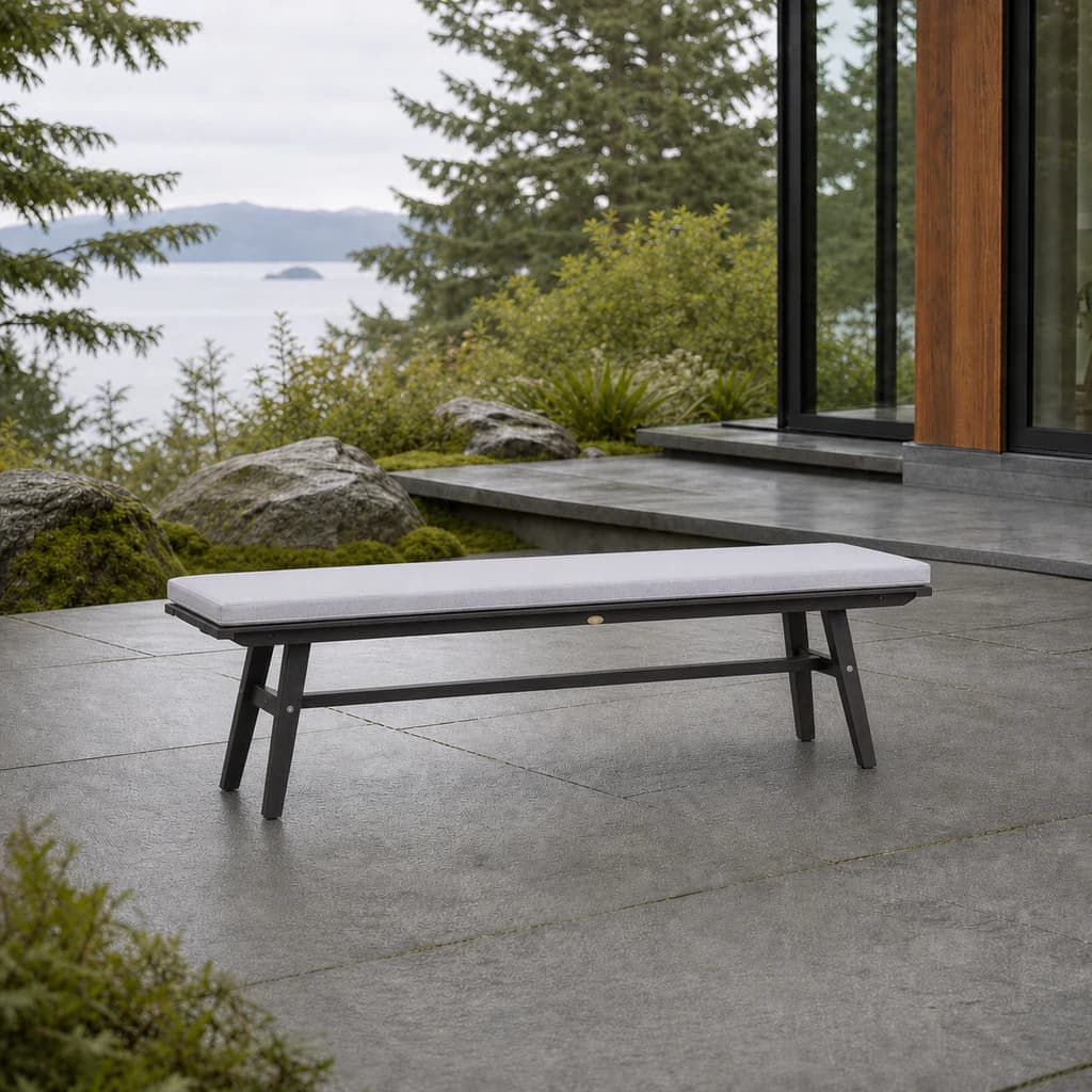 Ratana FN61147 Canbria backless bench with pale cushion on a Pacific Northwest stone patio.