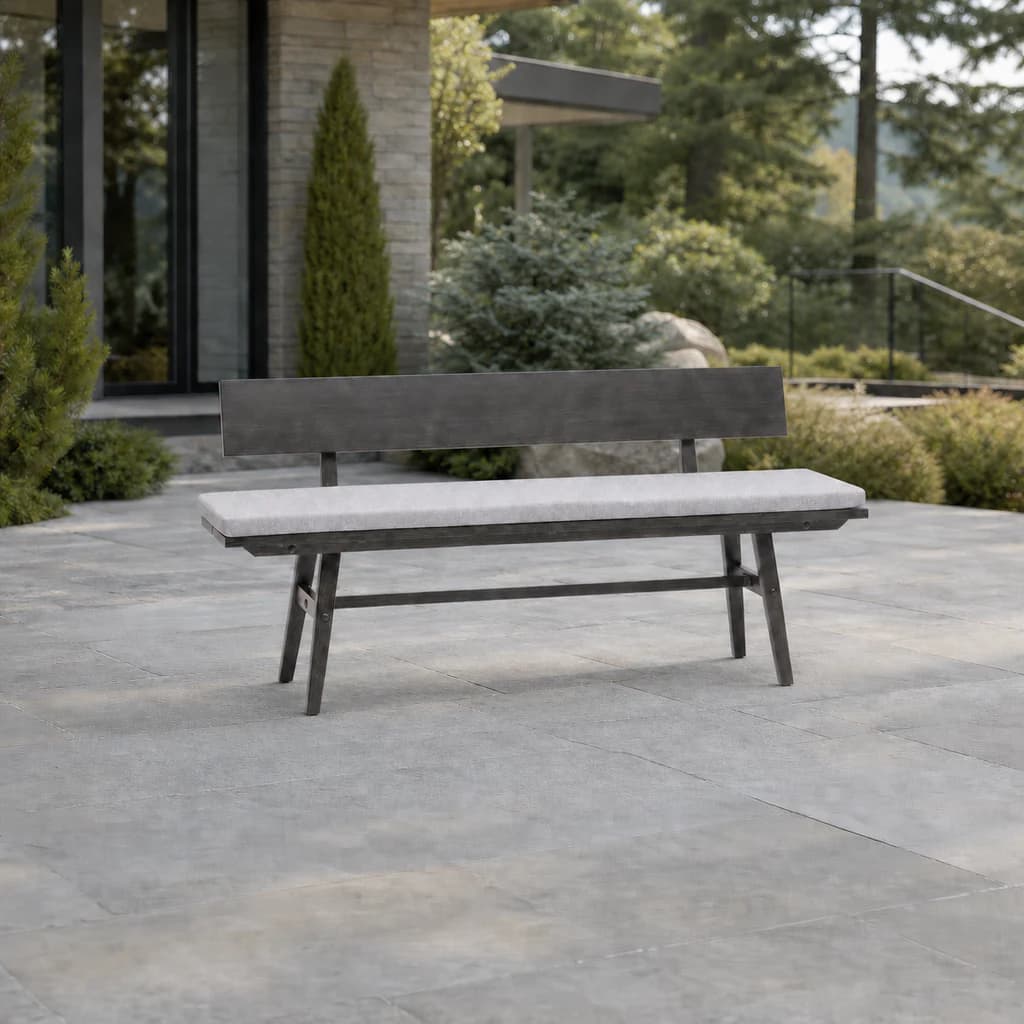 Ratana FN61149 Canbria bench with wide back and pale cushion on a landscaped stone patio.