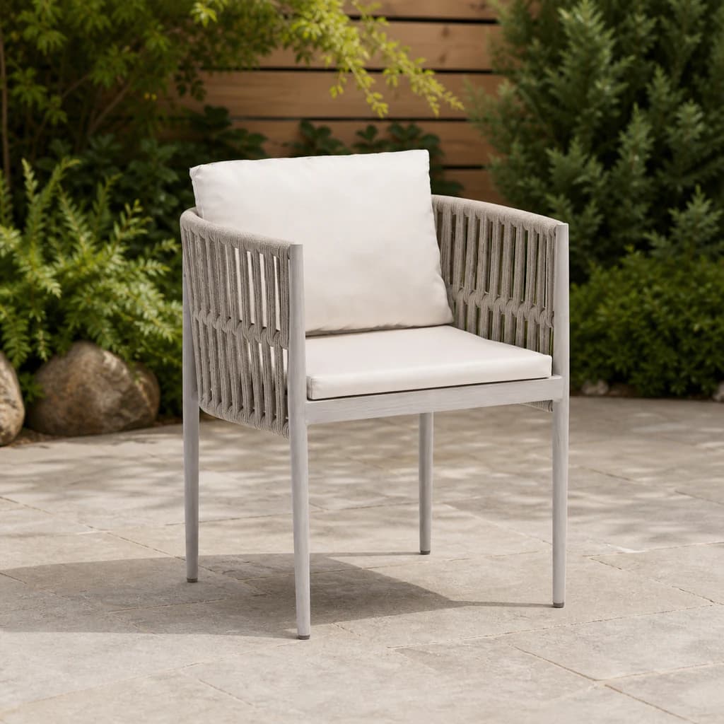 Ratana Lineas pale open-rope dining arm chair with plain white cushions on a garden patio.