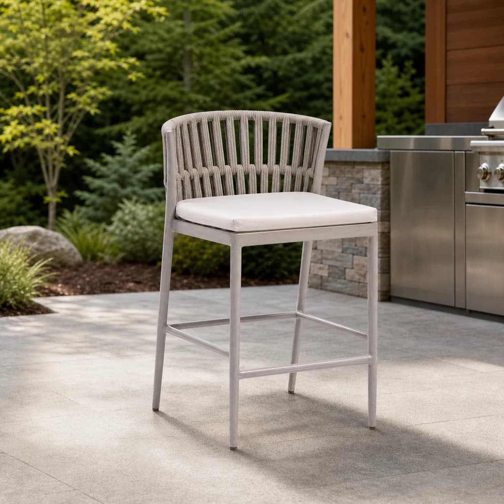 Ratana Lineas pale rope counter chair with a plain white cushion on a Pacific Northwest outdoor kitchen terrace.