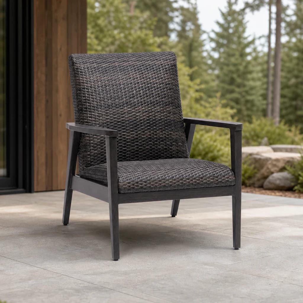 Ratana FN64901 Cabo San Lucas Club Chair in charcoal weave on a covered evergreen patio.