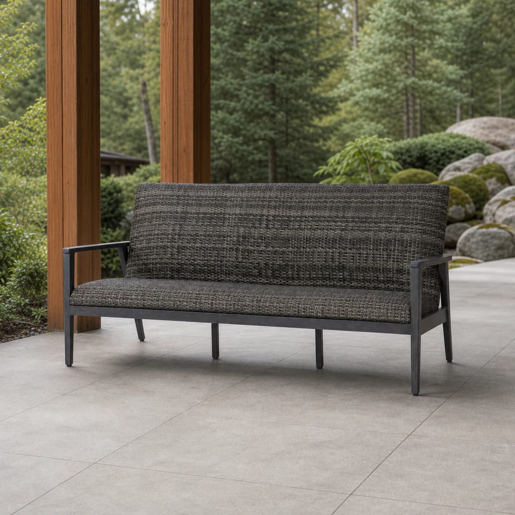 Ratana FN64903 Cabo San Lucas Sofa in charcoal weave on a covered forest patio.