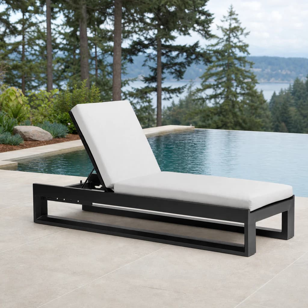 Ratana Avenue black adjustable lounger with plain white cushions beside a Pacific Northwest pool.