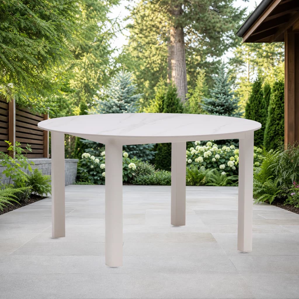Ratana FN68315 Hampshire 54-inch round dining table with umbrella hole on a garden patio.