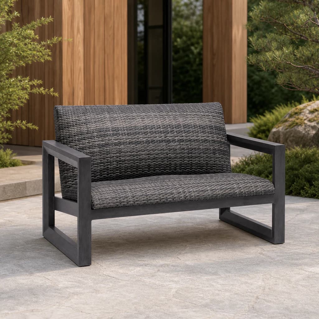 Ratana FN68402 Bergen Love Seat with charcoal aluminum frame and continuous gray woven seat and back on a cedar patio.