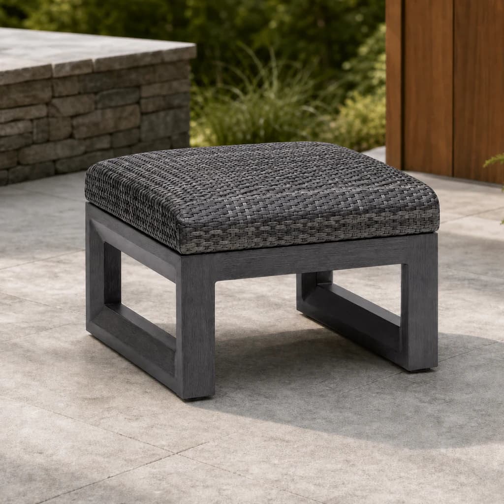 Ratana FN68416 Bergen Ottoman with charcoal aluminum frame and gray woven top on a premium stone patio.