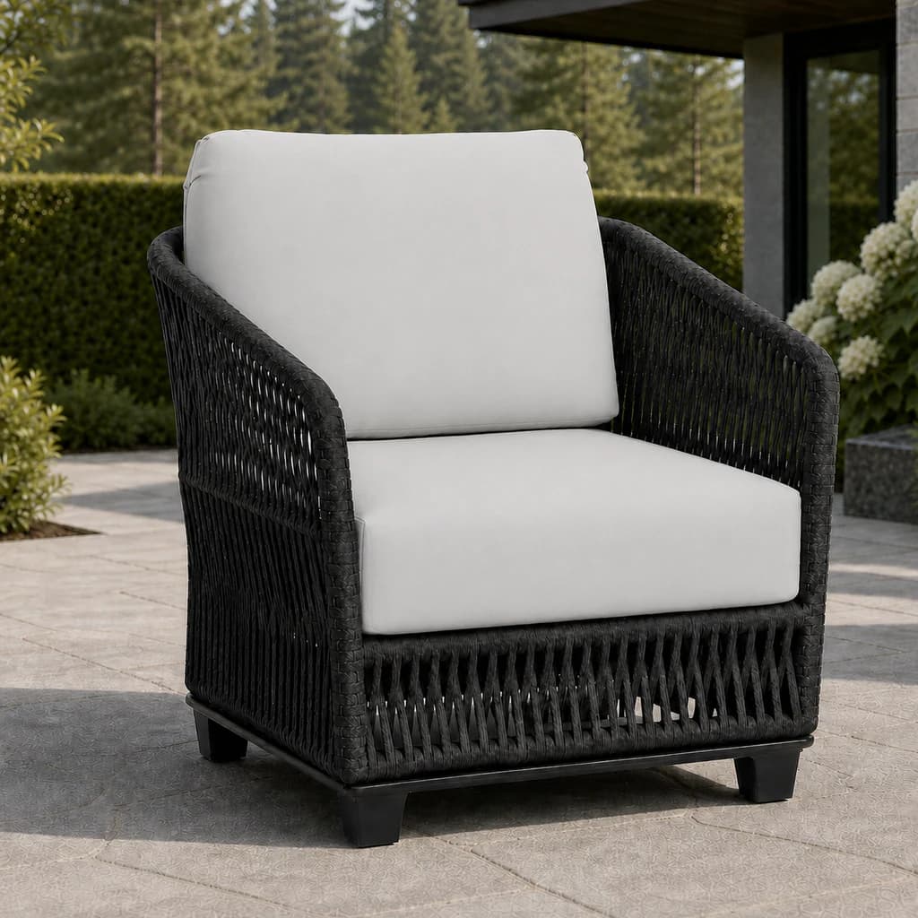 Ratana FN69001 Gemelli club chair on an evergreen garden patio.