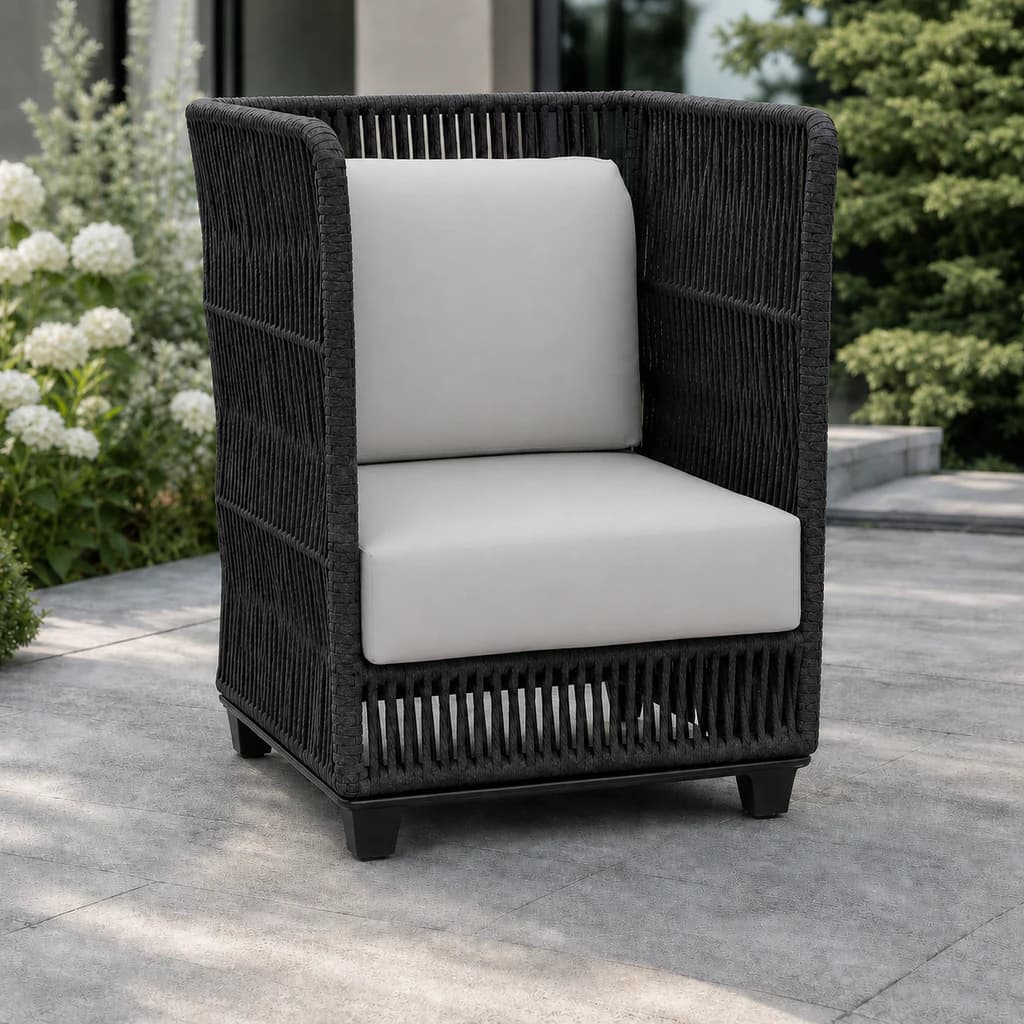 Ratana FN69085 Gemelli highback chair on an evergreen garden patio.