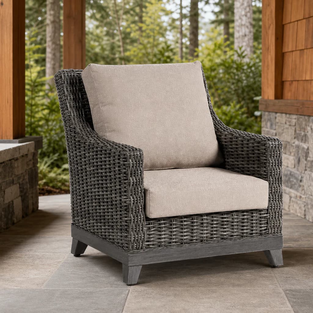 Ratana FN69301 Budapest Club Chair with charcoal woven frame and pale cushions on a covered evergreen patio.