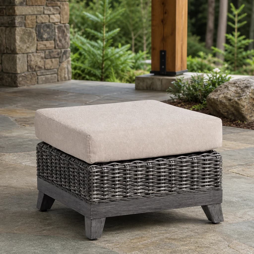 Ratana FN69316 Budapest Ottoman with pale cushion and charcoal woven base on a stone patio.