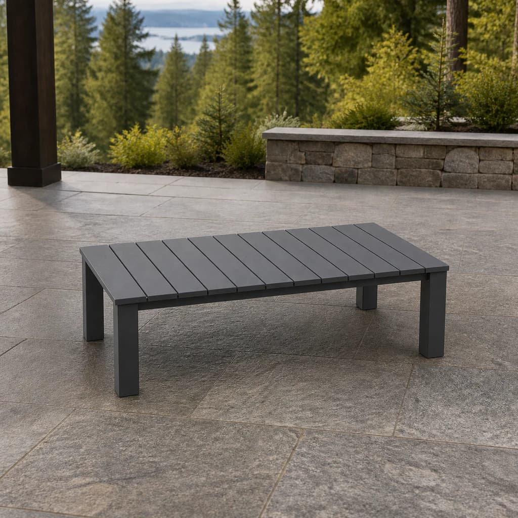 Ratana FN69404-T52 Sunbury 29-by-52-inch low Coffee Table in graphite on an evergreen patio.