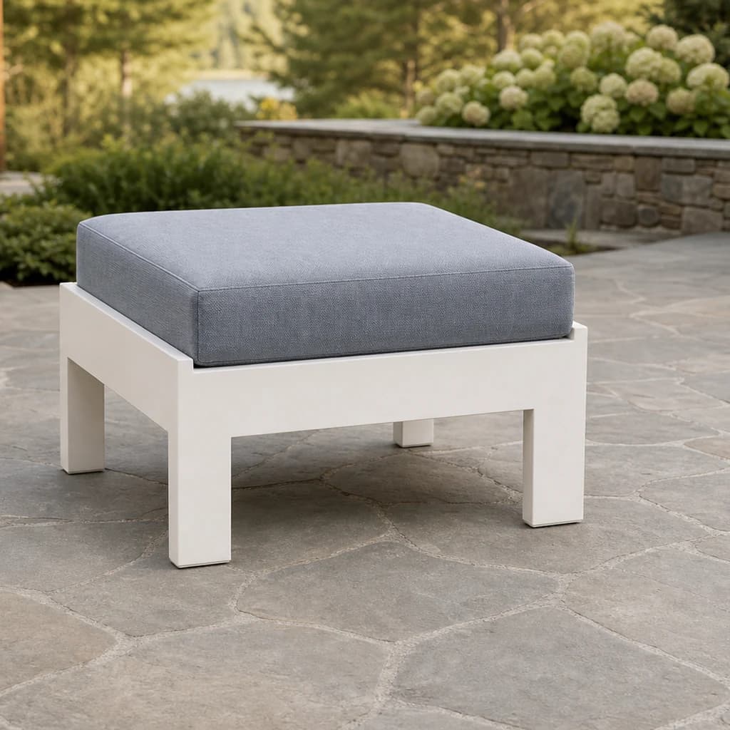 Ratana Vienna ottoman with white aluminum frame and one plain blue-gray cushion on a Pacific Northwest terrace.