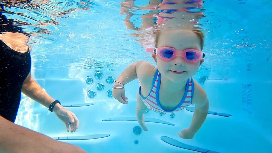 Child swimming in the family zone of a swim spa