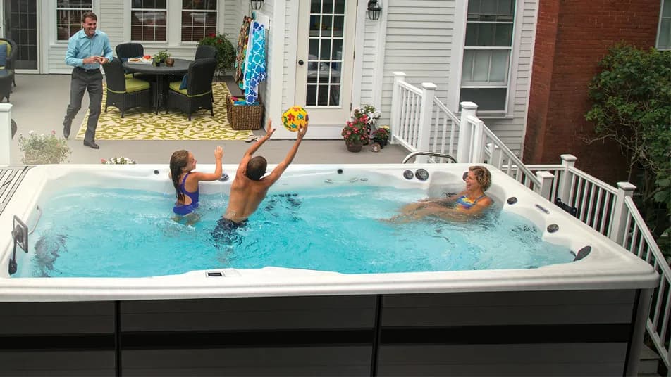 Family enjoying time together in a Bishop's Outdoor Living swim spa