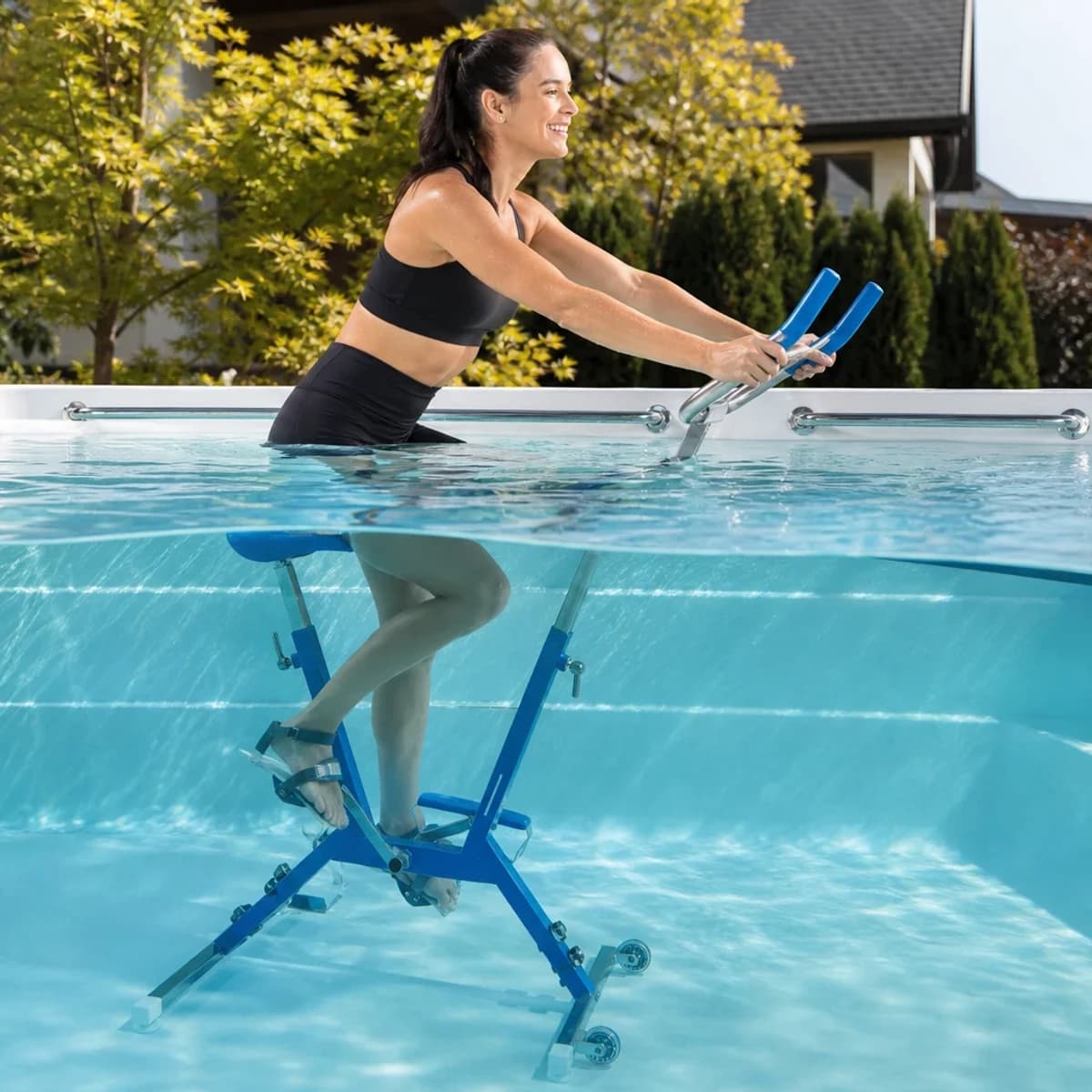 Endless Pools Aquabike being used by an adult in a swim spa filled with water