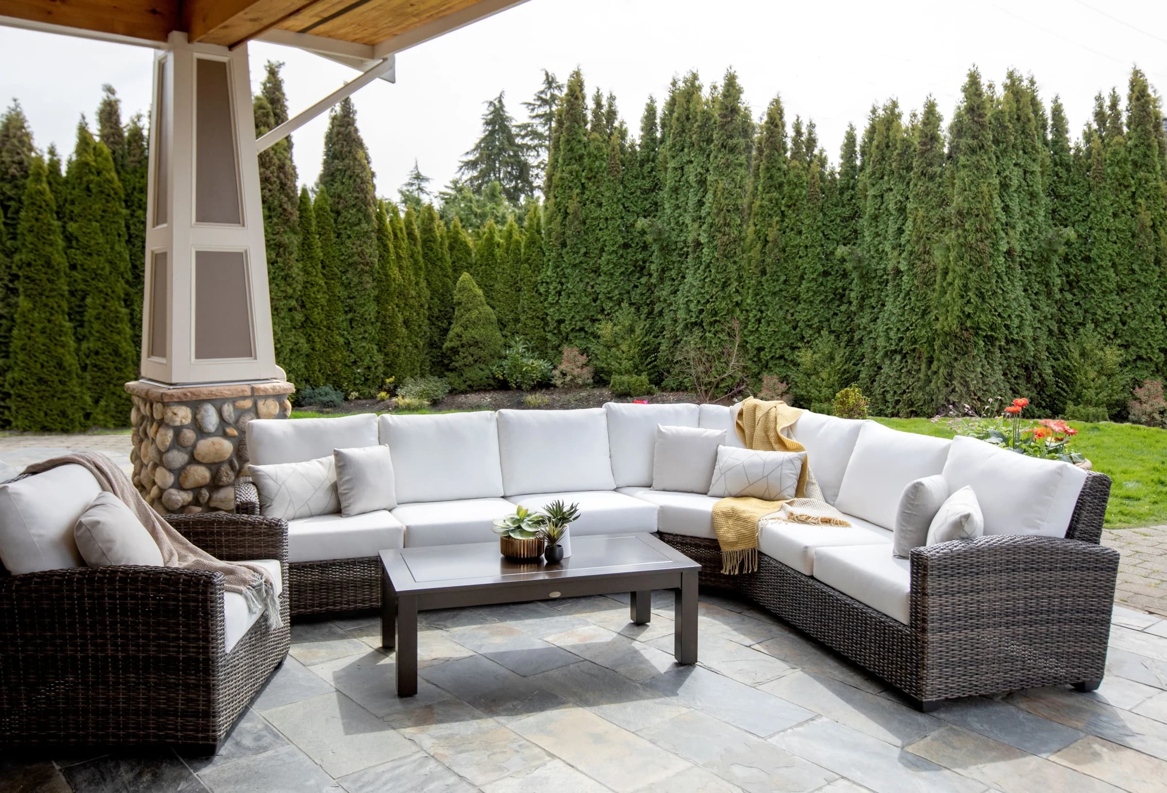 Coordinated Ratana sectional, lounge chair, and coffee table in a complete covered-patio setting